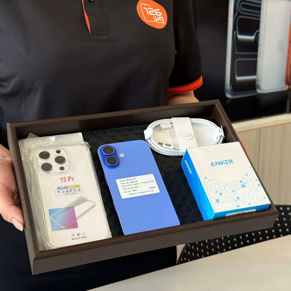 Nhân viên 126.vn giao iPhone 16 cũ cho khách hàng tại cửa hàng Vĩnh Long